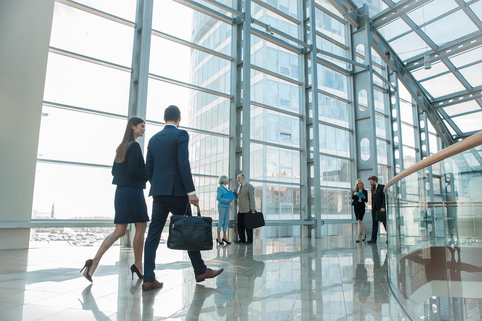 business people walking in glass building